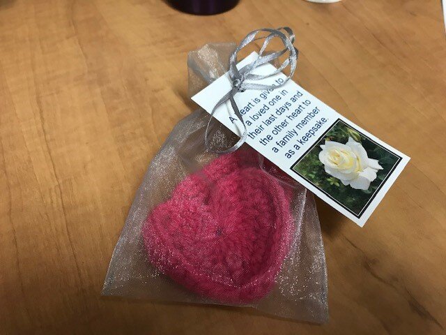 A sewn heart placed in a bag with a personalized note