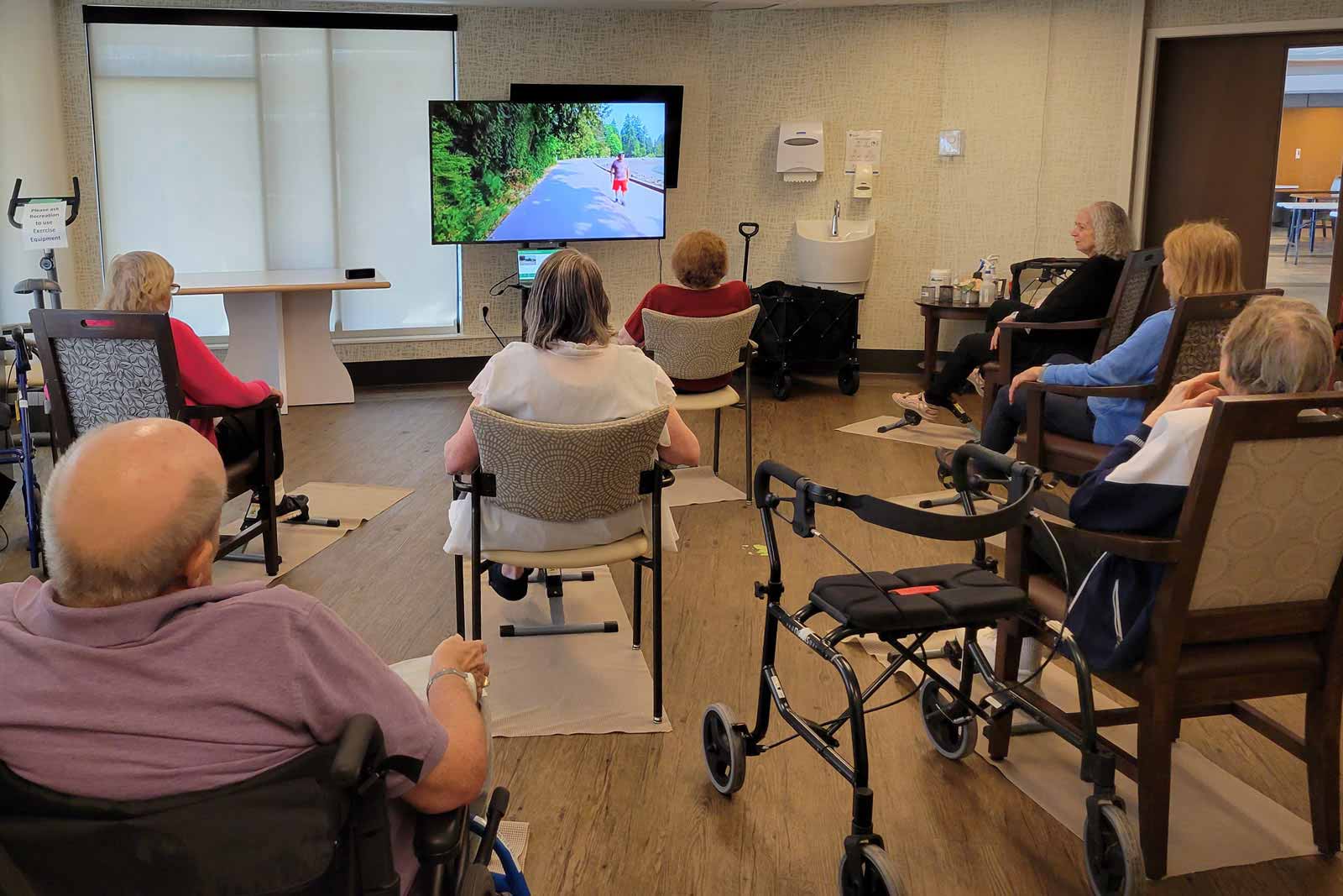 Seniors watching a video on a Motiview screen