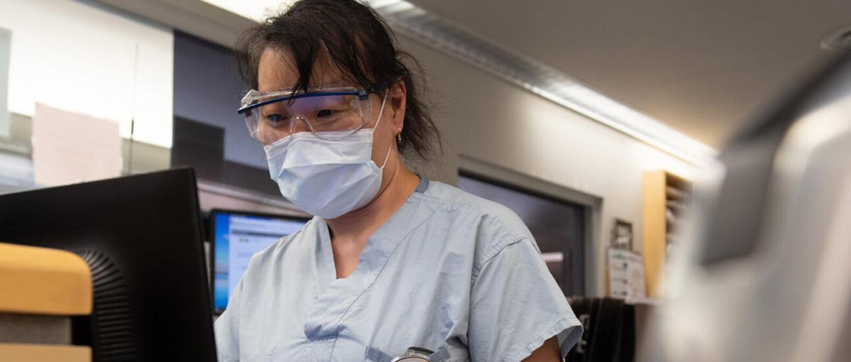 Registered nurse Kayo Nakano working on a computer