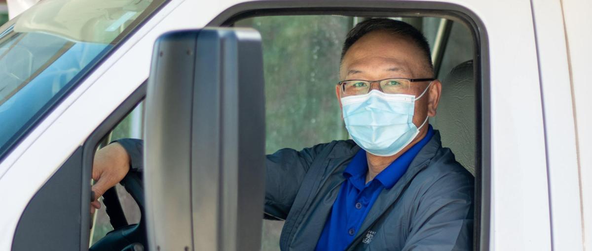 A photo of same in the driver's seat of his transport van.