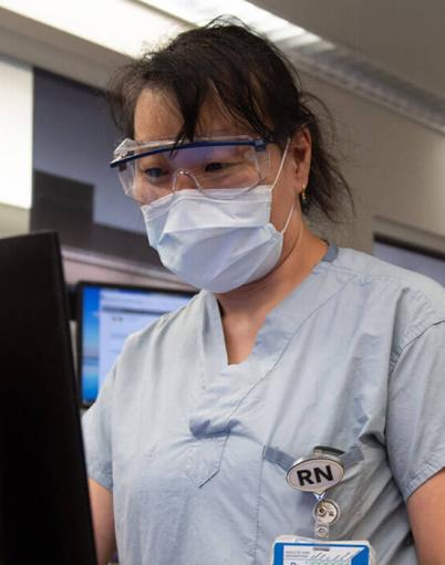 Registered nurse Kayo Nakano working on a computer