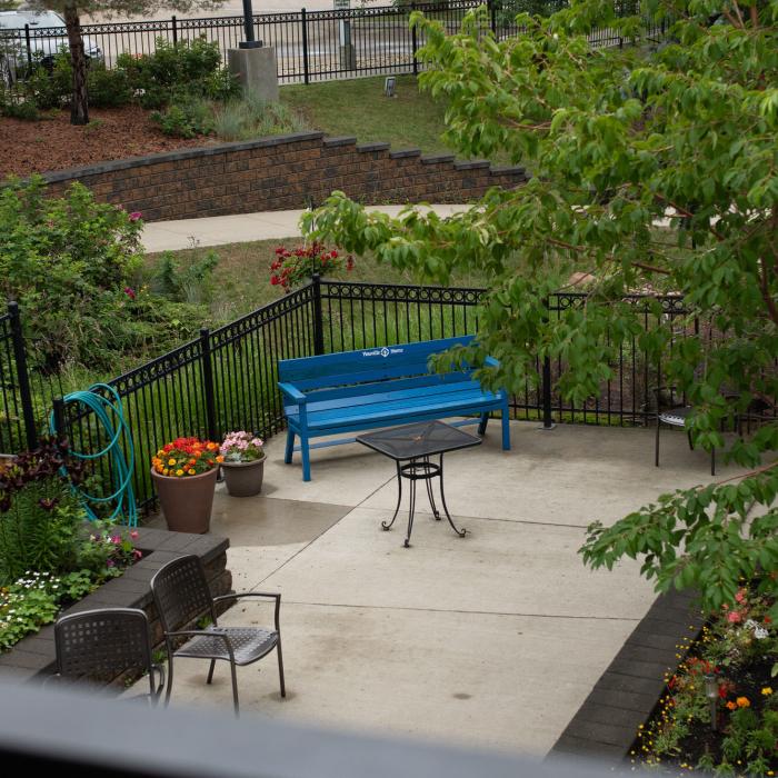 Outdoor garden with wrought iron railings and seating 