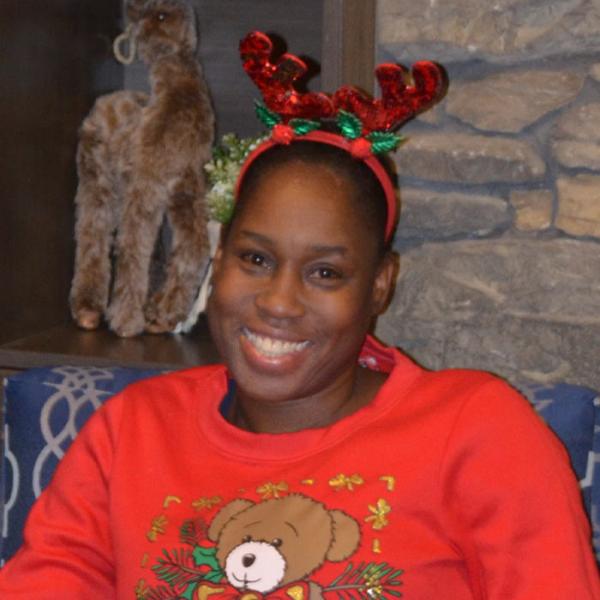 Allison Sinclair Graham sits among festive holiday decorations