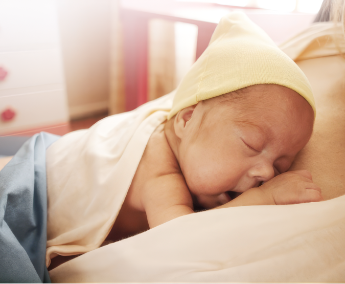 Baby sleeping on a parent's chest